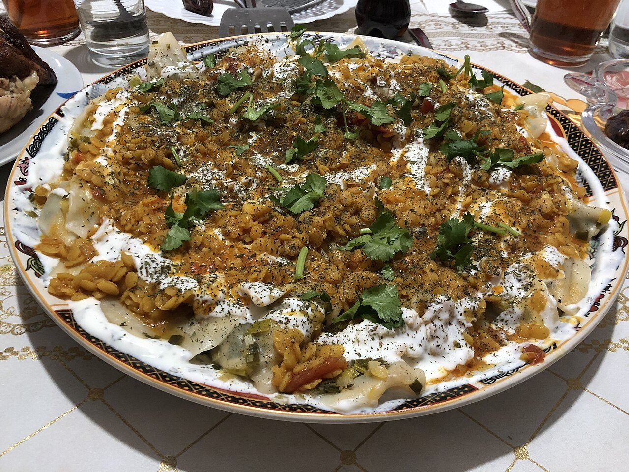 Representative photograph of Afghan Aushak. The photographed topping differs from this vegetarian tomato-and-lentil sauce.