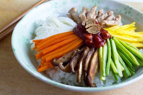 Representative photograph of Bibimbap. The photograph has different toppings and does not show the fried egg in this draft.