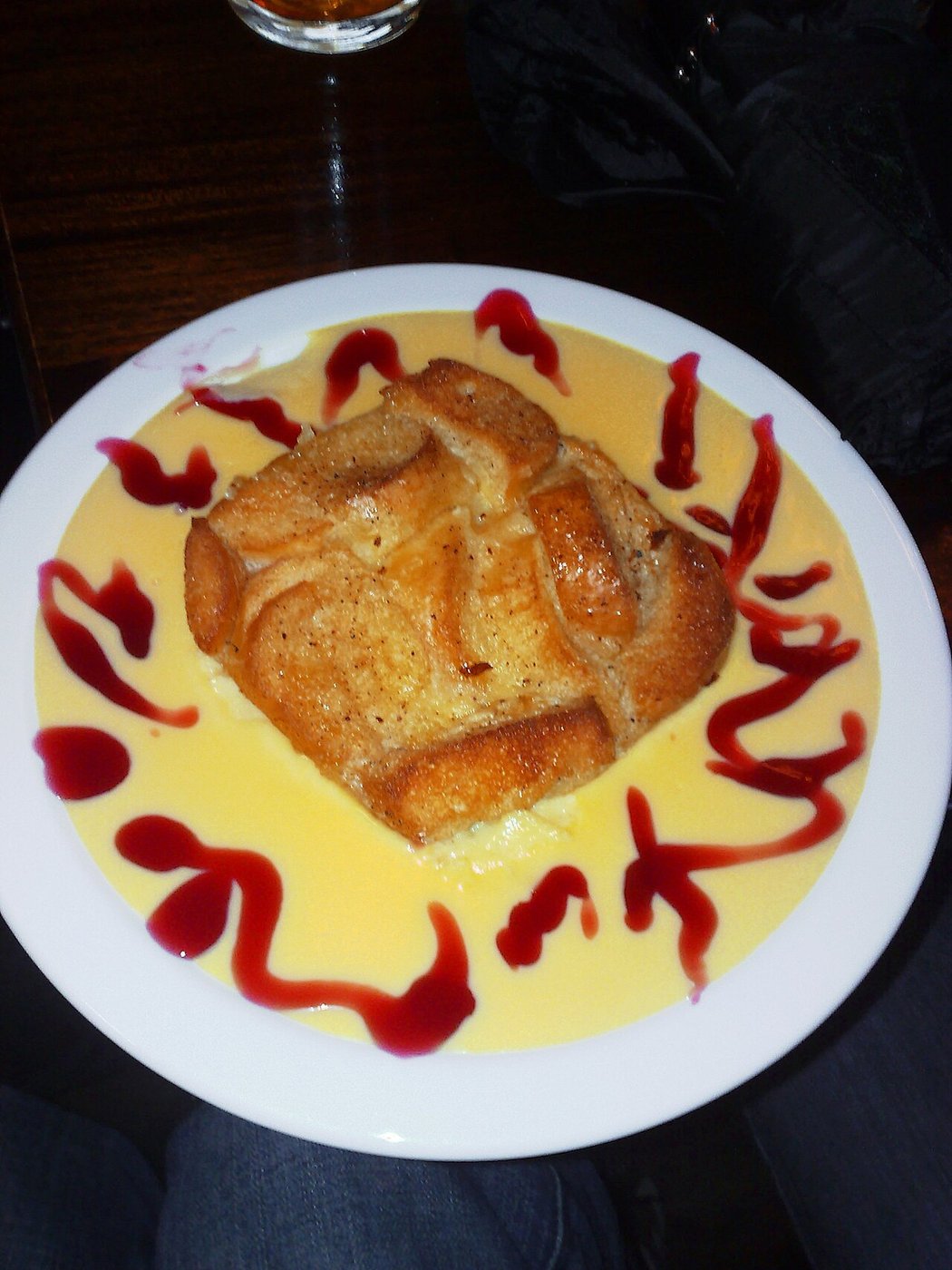 Representative photograph of Bread and Butter Pudding. The photograph includes custard and fruit sauce not included in this draft.