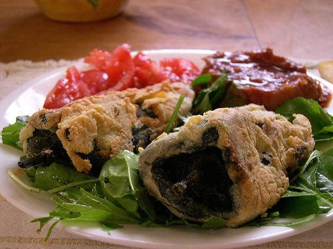 Representative photograph of Chiles Rellenos. The photograph includes side salad and uses a different presentation from this draft.