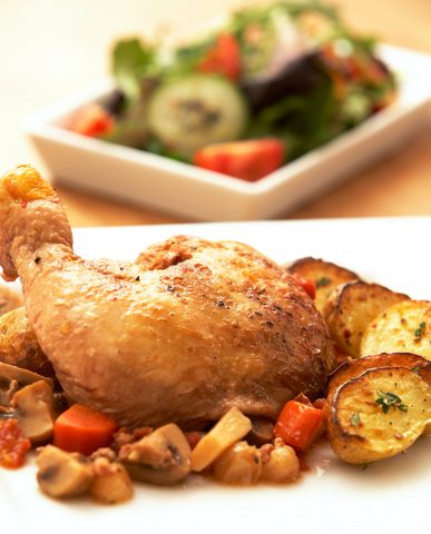 Representative photograph of Coq au Vin. The photograph includes side vegetables and a different-looking wine sauce; this draft uses red wine.