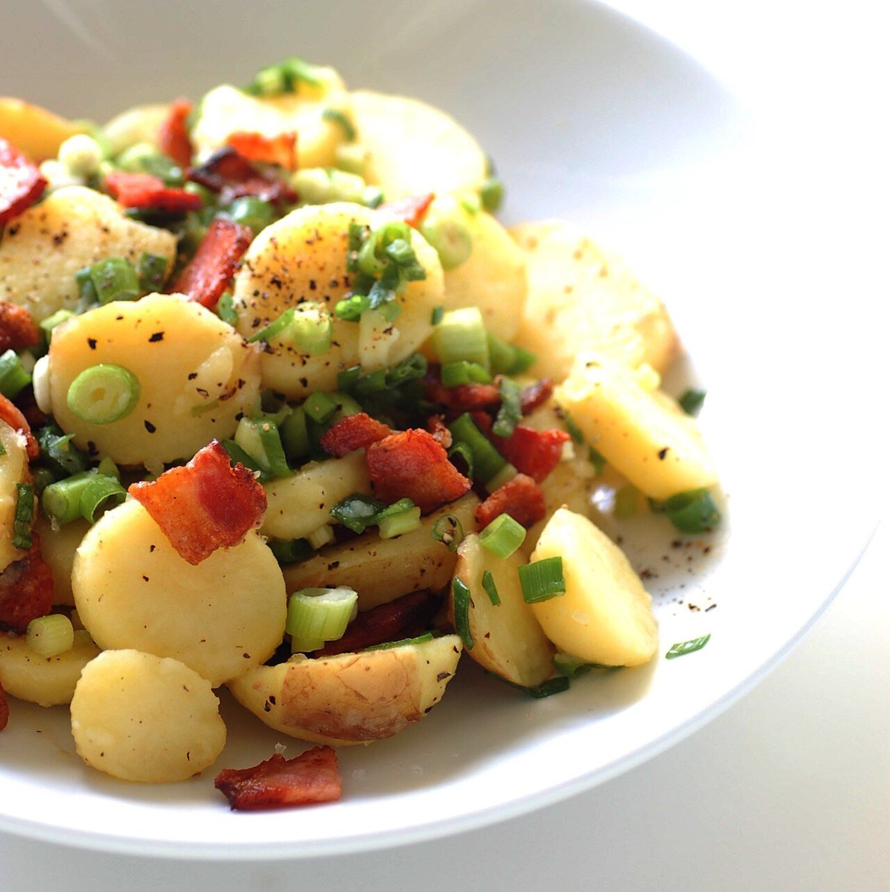 Representative photograph of German Potato Salad. The photograph includes additional vegetables beyond the onion and chives in this draft.