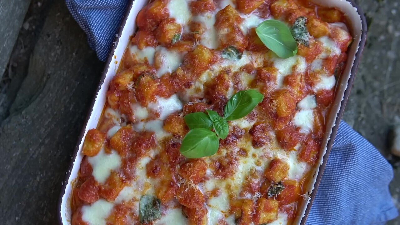 Representative photograph of Gnocchi with Tomato Sauce. The photo shows gnocchi baked with cheese in tomato sauce; this draft boils gnocchi and serves it in tomato sauce without baking.