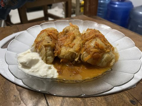 Representative photograph of Golubtsy. The photograph includes sour cream and a different sauce presentation from this draft.