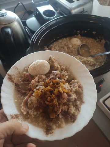 Representative photograph of Haleem. The source does not establish the meat variety. This draft uses beef; the photographed garnish also differs.