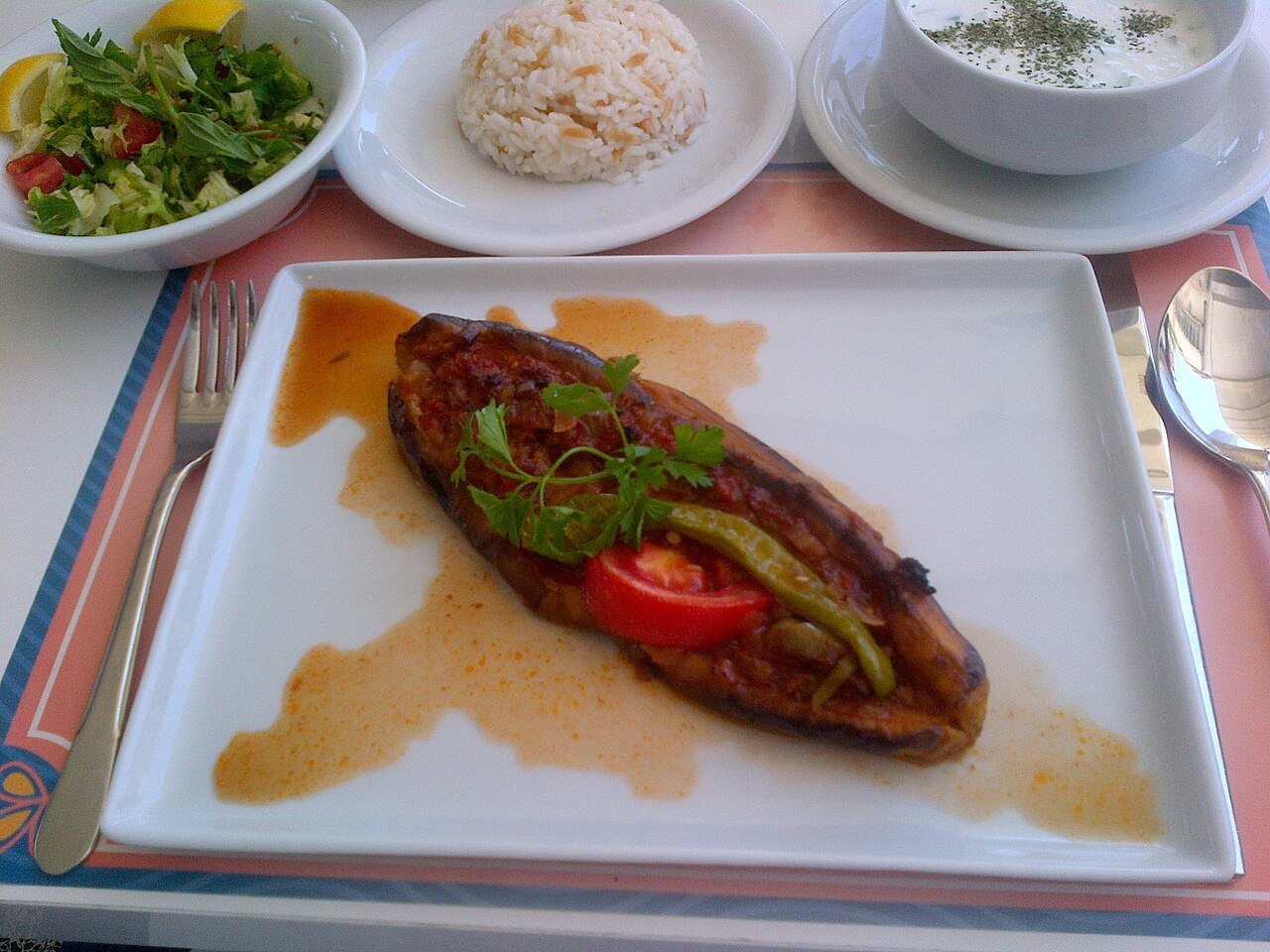 Representative photograph of Karniyarik. The photograph includes side dishes not included in this draft.