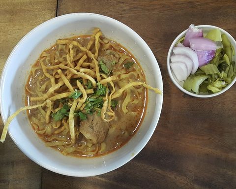Representative photograph of Khao Soi. The photograph includes separate pickled vegetables and garnish not included in this draft.
