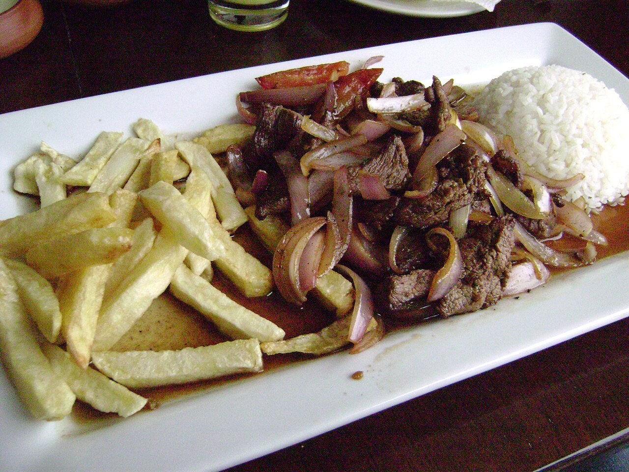 Representative photograph of Lomo Saltado. The photograph includes rice not included in this draft.