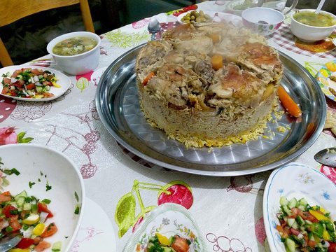 Representative photograph of Maqluba. The photograph includes several side dishes not included in this rice recipe.