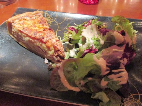 Representative photograph of Quiche Lorraine. The photograph includes a side salad not included in this draft.