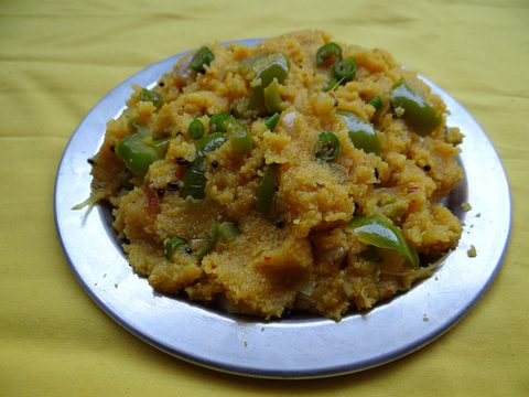 Semolina upma with visible vegetables on a plate