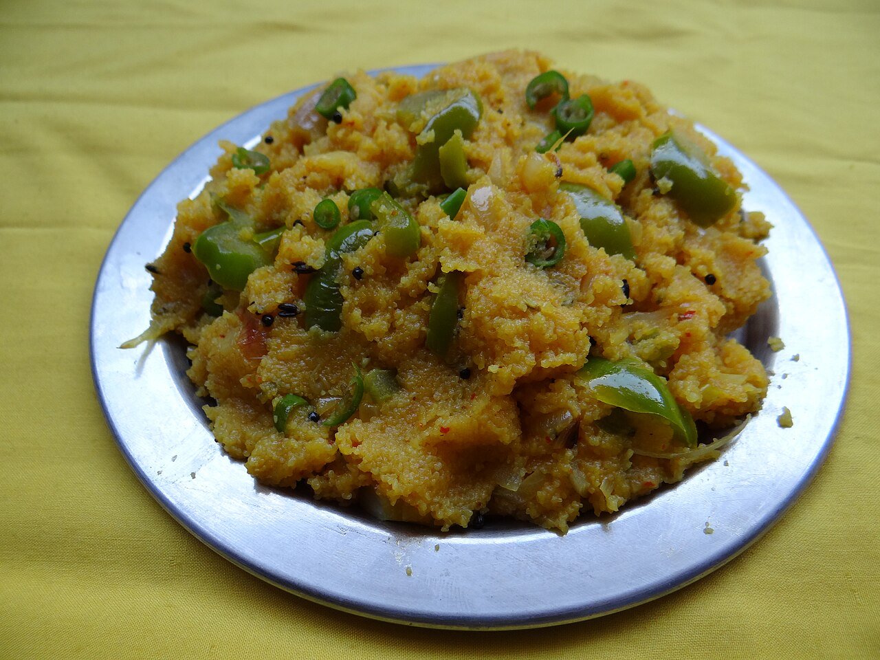 Semolina upma with visible vegetables on a plate