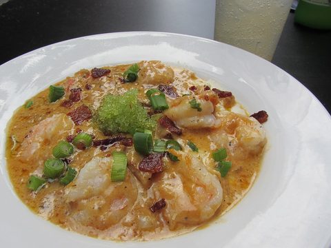 Representative photograph of Shrimp and Grits. The photograph includes extra garnish not included in this draft.