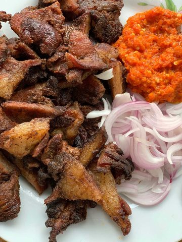 Representative photograph of Suya. The photograph includes onion and pepper sauce not included in this draft.