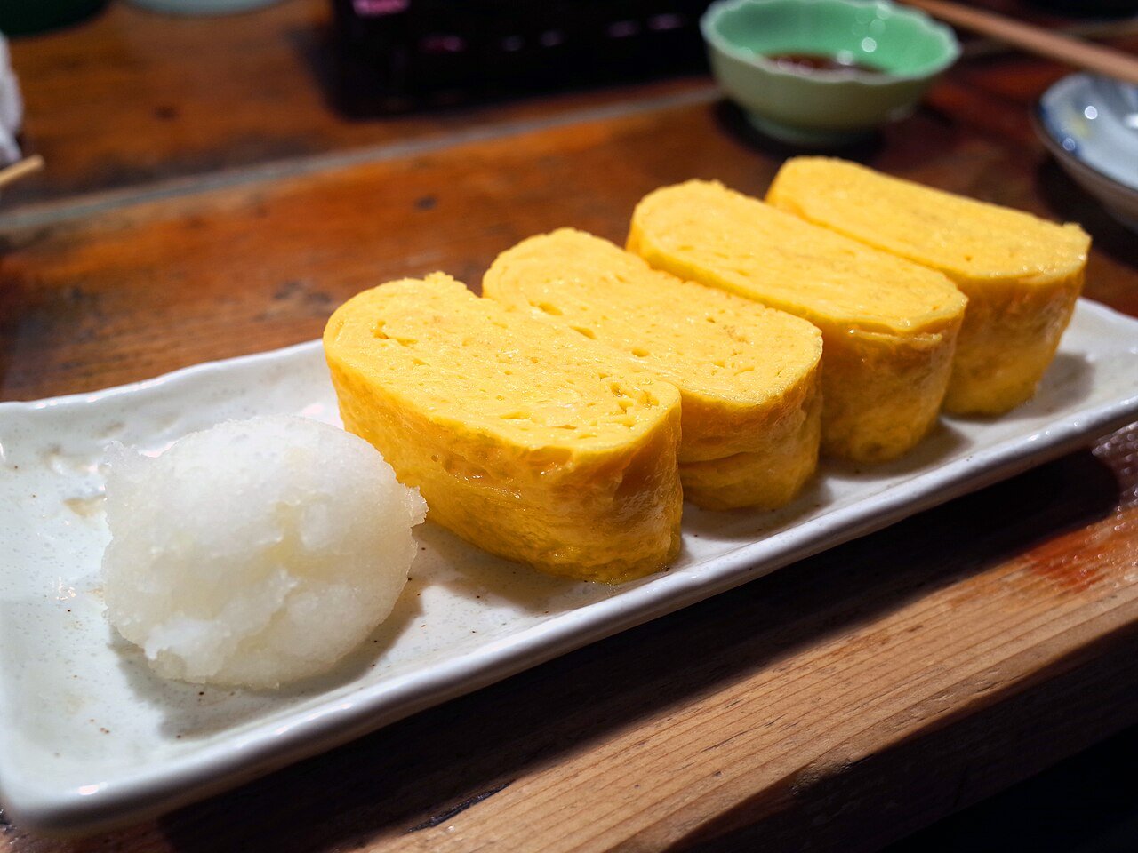 Representative photograph of Tamagoyaki. The photograph includes grated daikon, which is not part of this draft.