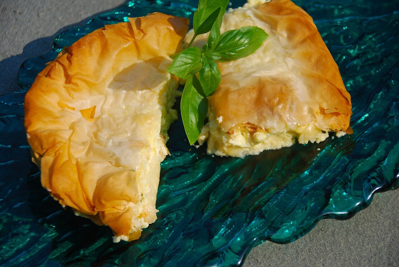 Representative photograph of Tiropita. The photograph shows a folded cheese pie; this draft makes a layered tray pie.